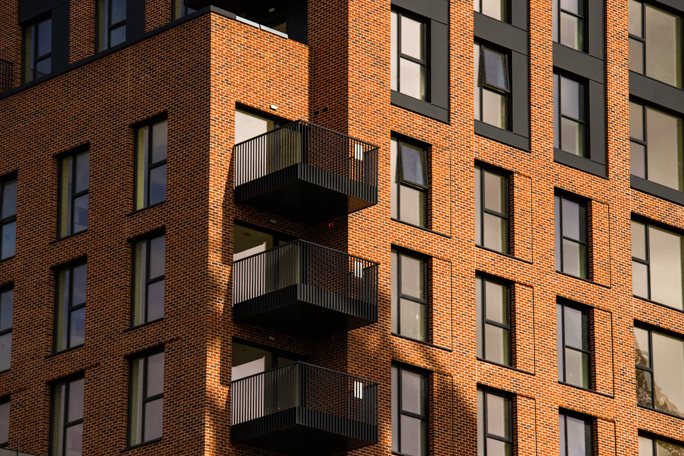A modern brick apartment building in Dublin with black balconies