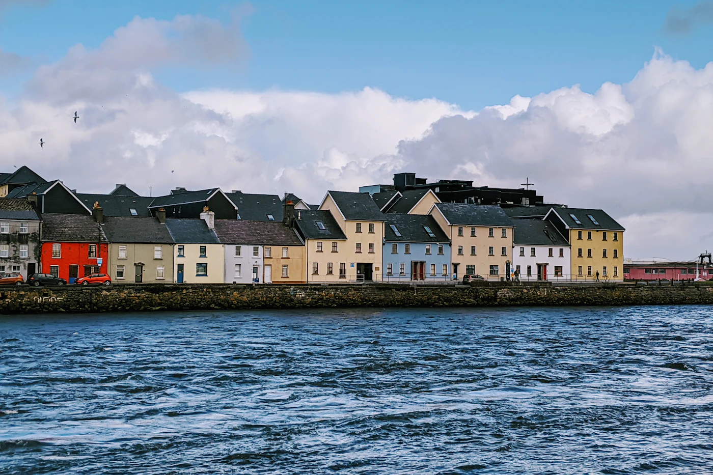 Colourful terraced houses along the water at the Long Walk in Galway